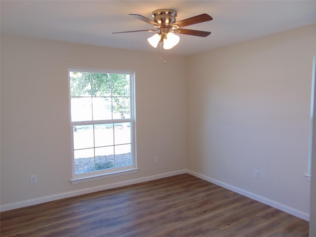 empty room featuring dark hardwood / wood-style flooring and ceiling fan