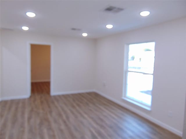 unfurnished room with wood-type flooring