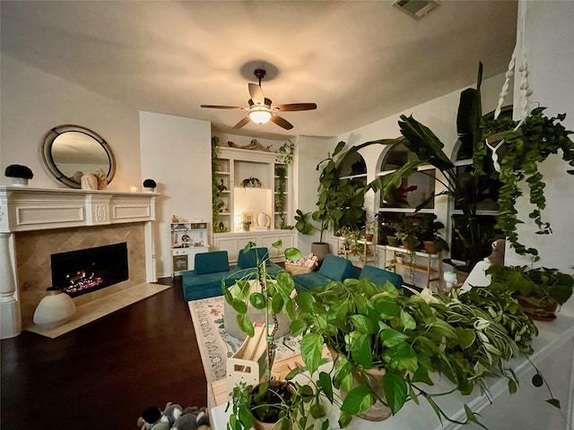 living room featuring a fireplace, ceiling fan, and hardwood / wood-style flooring