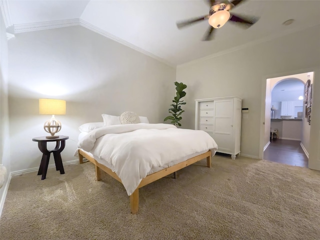 bedroom featuring vaulted ceiling, carpet, ornamental molding, and ceiling fan