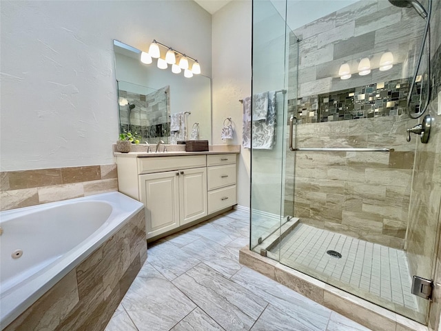 bathroom with shower with separate bathtub and vanity