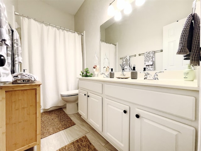 bathroom featuring toilet and vanity