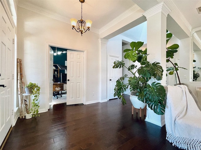 entryway with an inviting chandelier, crown molding, and dark hardwood / wood-style floors