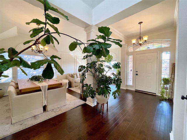 foyer entrance with dark wood-type flooring and a chandelier