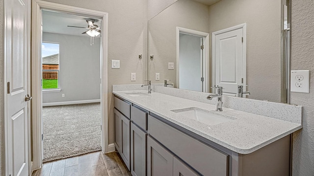 bathroom featuring ceiling fan and vanity