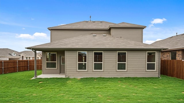 rear view of house featuring a yard and a patio area