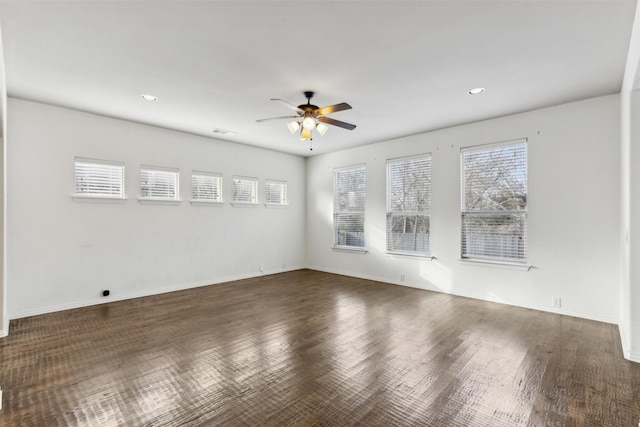 unfurnished room with ceiling fan and dark wood-type flooring