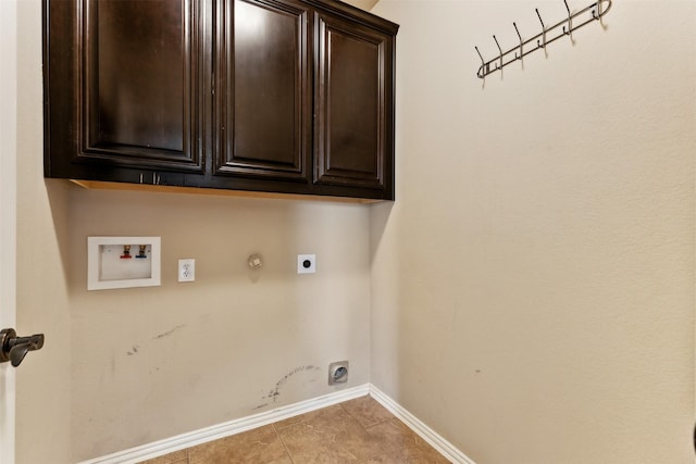 clothes washing area with cabinets, tile patterned flooring, hookup for a washing machine, hookup for a gas dryer, and electric dryer hookup