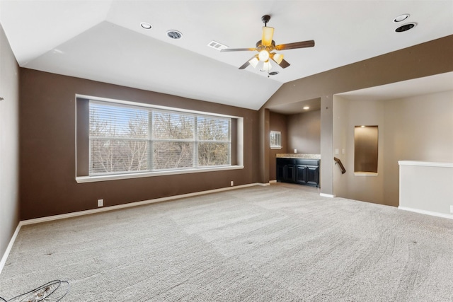 unfurnished living room featuring ceiling fan, vaulted ceiling, and light carpet