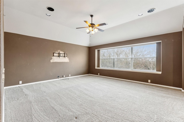 spare room with carpet floors, ceiling fan, and vaulted ceiling