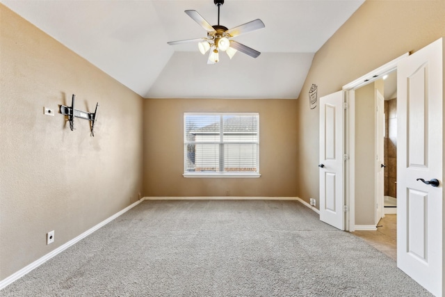 unfurnished bedroom with ceiling fan, light carpet, and lofted ceiling