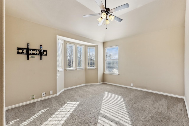 unfurnished room featuring lofted ceiling, carpet floors, ceiling fan, and a healthy amount of sunlight