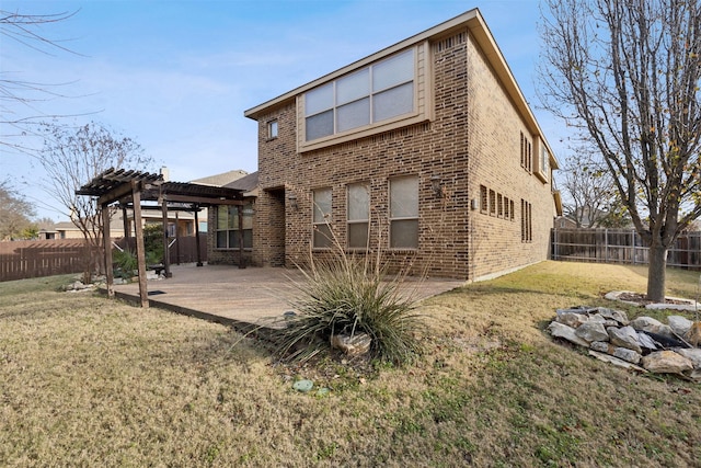 back of property with a patio, a yard, and a pergola