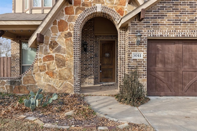 view of exterior entry with a garage