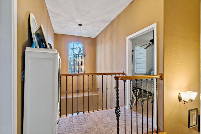 hallway featuring carpet flooring and an inviting chandelier