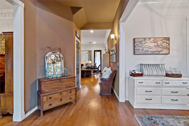 hall featuring light hardwood / wood-style floors and crown molding