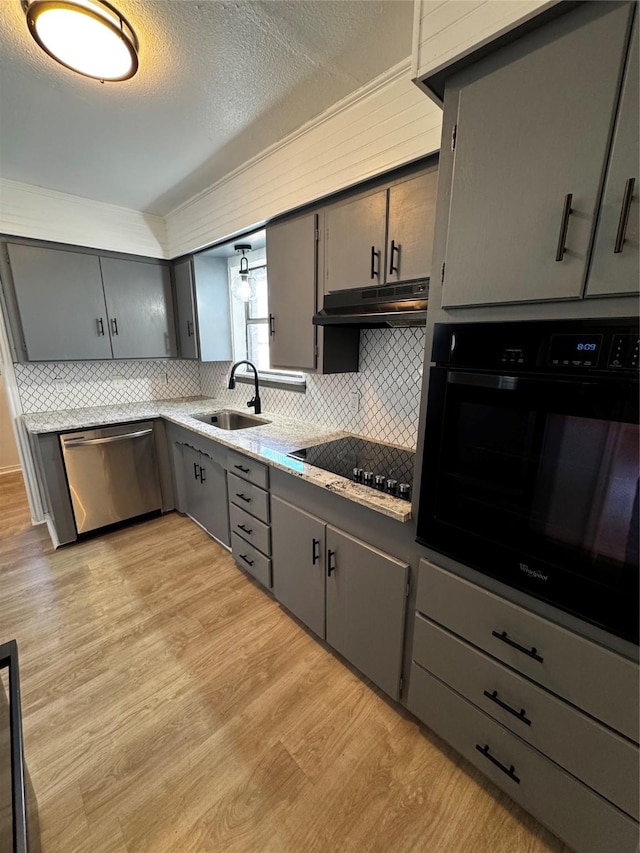 kitchen with gray cabinets, black appliances, a textured ceiling, sink, and tasteful backsplash