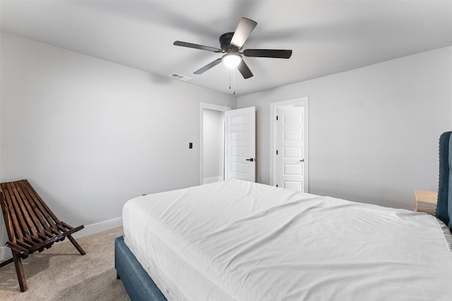 bedroom with ceiling fan and light carpet