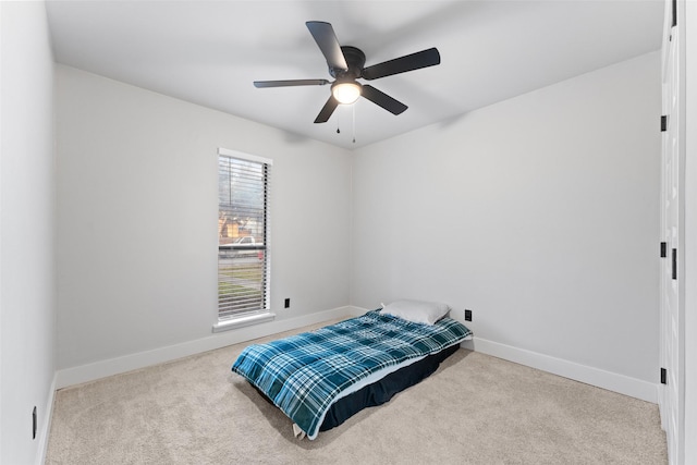 bedroom with light carpet and ceiling fan