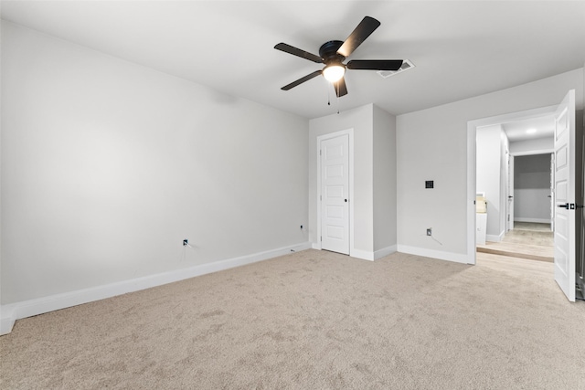 unfurnished bedroom featuring ceiling fan and light carpet