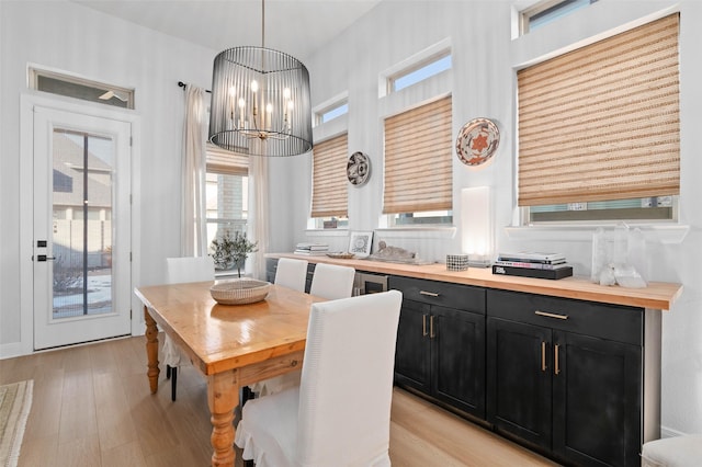 dining room featuring an inviting chandelier and light wood-type flooring