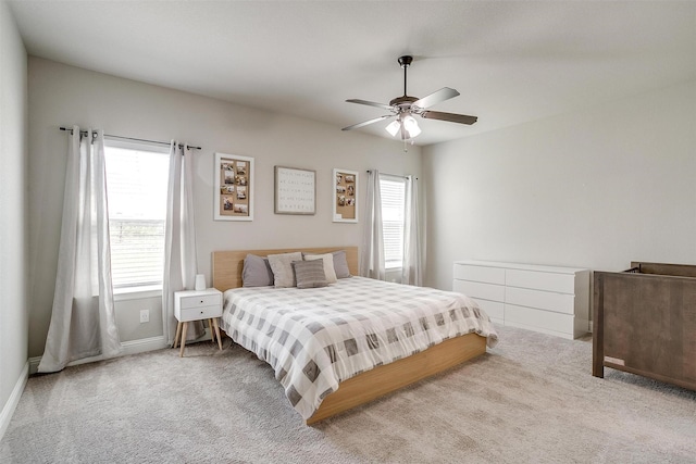 bedroom featuring ceiling fan and light carpet