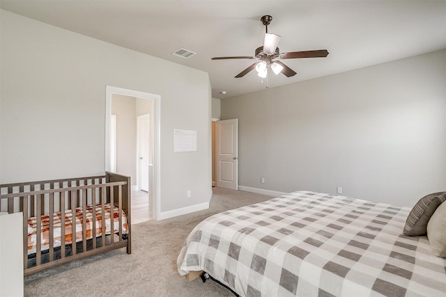 bedroom featuring ceiling fan and light carpet