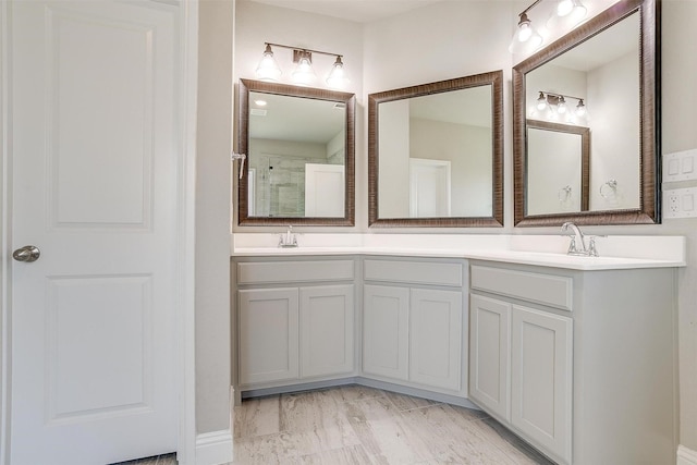 bathroom with walk in shower and vanity