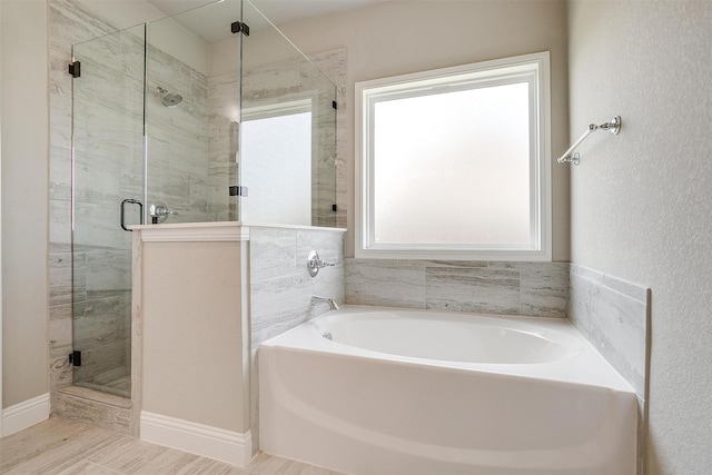 bathroom with shower with separate bathtub