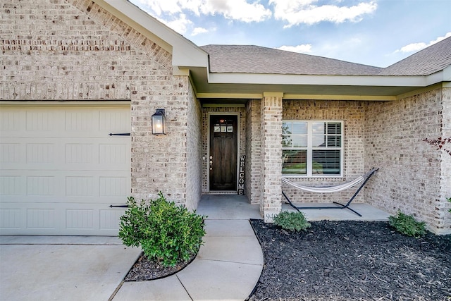 view of exterior entry featuring a garage