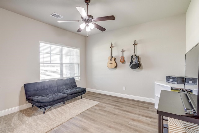 sitting room with light wood-type flooring and ceiling fan