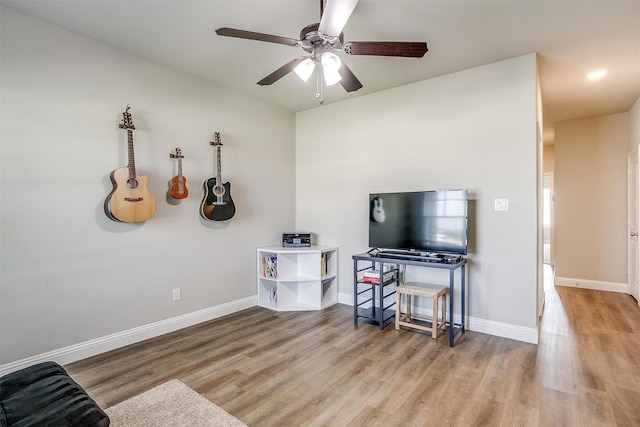 misc room with ceiling fan and light hardwood / wood-style floors