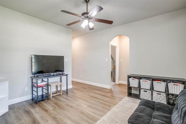 living room with ceiling fan and light wood-type flooring