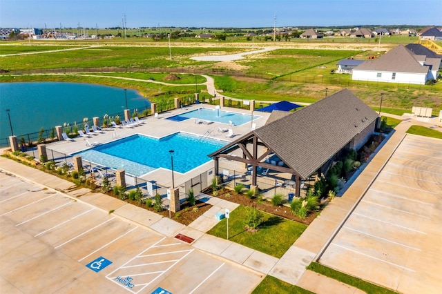 view of swimming pool with a water view