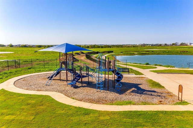 view of play area featuring a water view and a lawn