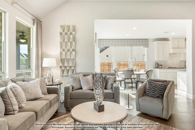 living room featuring vaulted ceiling and dark hardwood / wood-style floors