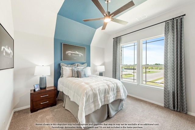 carpeted bedroom with multiple windows, ceiling fan, and vaulted ceiling