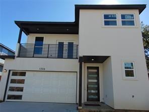 view of front facade with a balcony and a garage