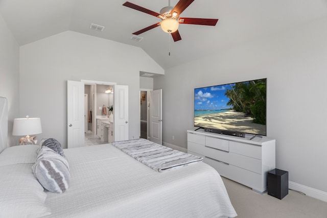 bedroom with ensuite bathroom, light carpet, ceiling fan, and vaulted ceiling