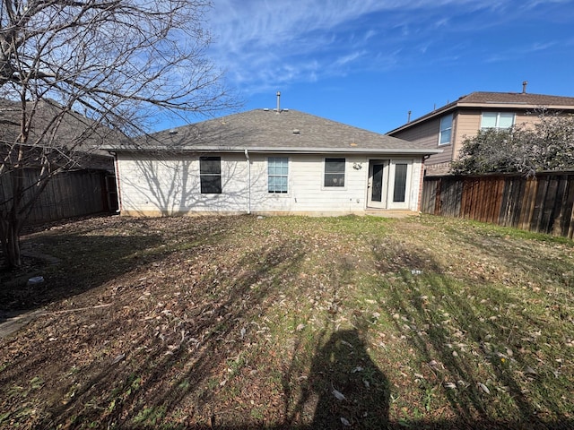 rear view of house featuring a yard