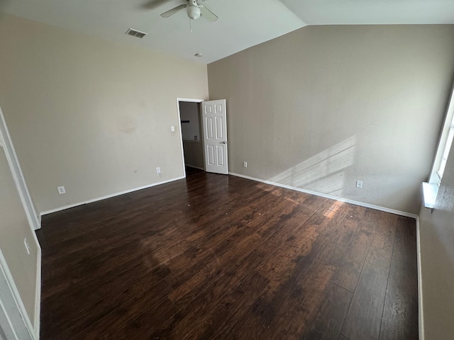 empty room featuring ceiling fan, dark hardwood / wood-style flooring, and vaulted ceiling