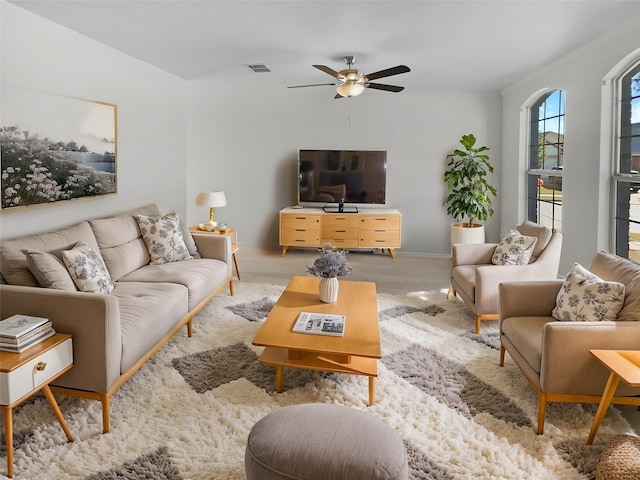 living room featuring ceiling fan and light carpet