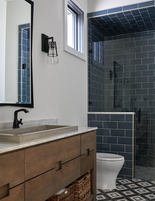 bathroom featuring walk in shower, vanity, and toilet