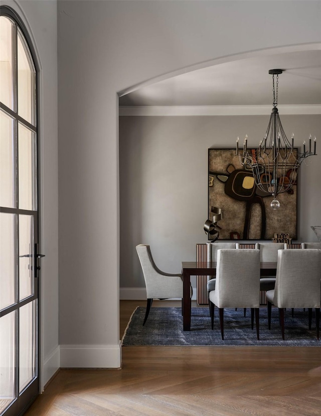 unfurnished dining area with an inviting chandelier and parquet floors