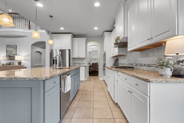 kitchen featuring white cabinets, pendant lighting, and sink