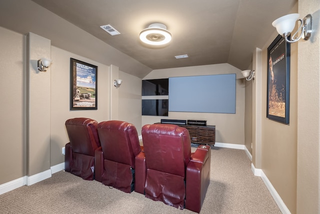 carpeted home theater with lofted ceiling