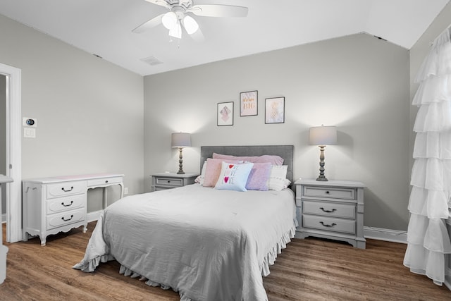 bedroom featuring vaulted ceiling, ceiling fan, and dark hardwood / wood-style floors