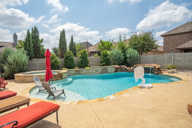 view of swimming pool featuring pool water feature, an in ground hot tub, and a patio