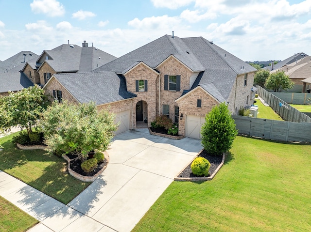 view of front of home with a front lawn and a garage