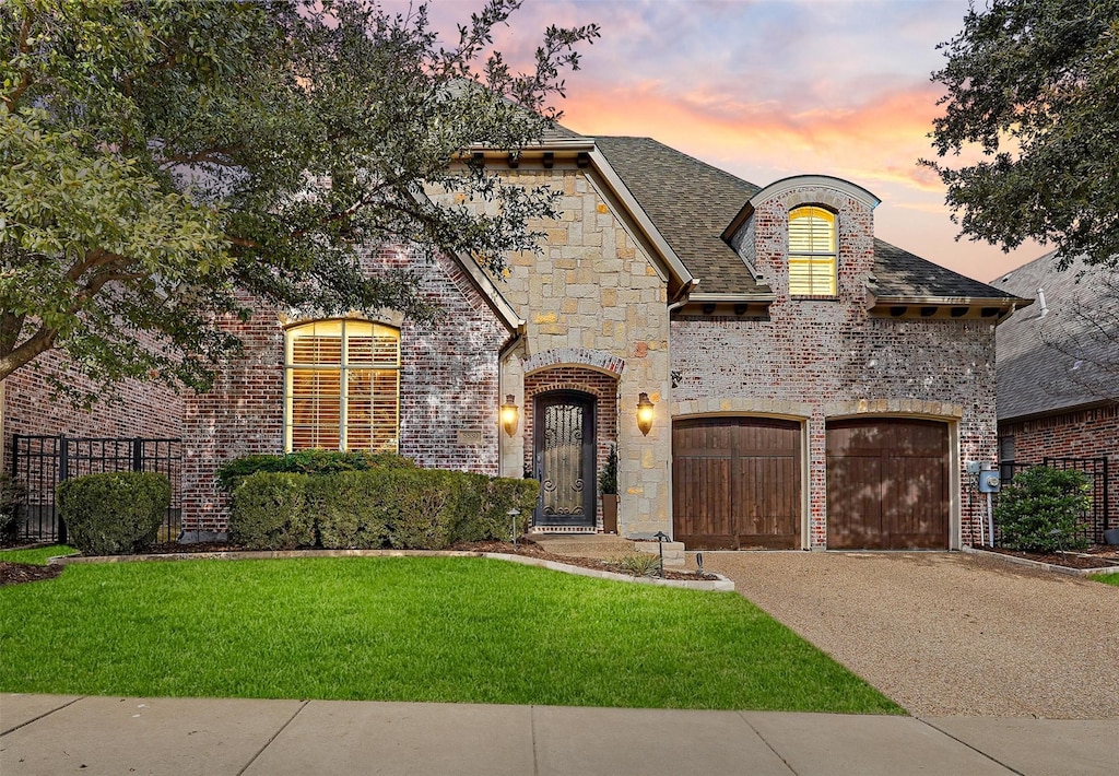 view of front facade with a lawn and a garage